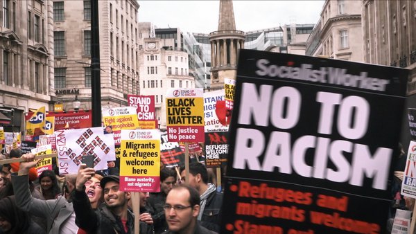 Protesters hold placards stating No to Racism at a demonstration in London